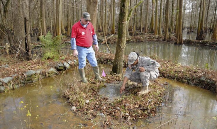 Louisiana National Guard Sgt. Aerrial Fredricks, a chemical, biological and radiological and nuclear specialist with Headquarters and Headquarters Company, 528th Engineer Battalion, and Steven Evans, a construction controller with the U.S. Army Corps of Engineers, inspect a sand boil in Newellton, La., Jan. 8, 2016. The LANG is conducting 24-hour levee patrols in the parishes of Concordia, East Carroll, Madison and Tensas to inspect for any leaks or seepage that has been caused by the winter river flooding. (U.S. Army National Guard photo by Sgt. Noshoba Davis)