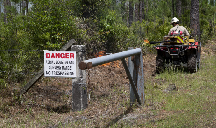 Steven Toro-Henriquez, 325th Civil Engineer Squadron senior firefighter, burns vegetation during a prescribed burn at Moody Air Force Base, Georgia, April 21, 2022. The 23rd Civil Engineer Squadron teamed up with firefighters and wildland fire dispatchers from Eglin Air Force Base and Tyndall Air Force base to conduct the prescribed burning. (U.S. Air Force photo by Senior Airman Jasmine M. Barnes)