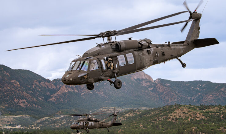 U.S. AIR FORCE ACADEMY, Colo. -- Two UH-60's from the 4th Infantry Division Combat Aviation Brigade out of Ft. Carson take off from Davis Airfield at the U.S. Air Force Academy in Colorado Springs, Colo. on July 29, 2024. The aircraft, bound for the Pinon Canyon Maneuver Site at nearby Fort Carson, carried Academy senior leadership to tour a training site where Academy cadets participate in Combat Survival Training (CST), a program that teaches sophomores medical care, food preparation, aircraft signaling, and navigation essentials for survival. (U.S. Air Force photo/Dylan Smith)
