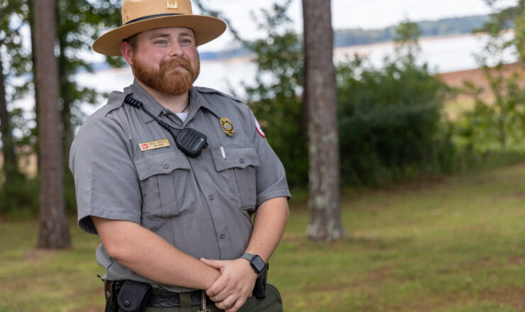 Park Ranger Mike Linville, event organizer for the Special Day for Special People, stands by the lake at Rocky Point Park. Linville has been instrumental in coordinating this annual event, which provides outdoor activities and community engagement for individuals with special needs and the elderly.