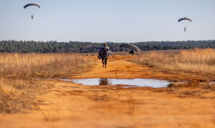 U.S. Army Green Berets assigned to 3rd Special Forces Group (Airborne) descend to Sicily Drop Zone during Randy Oler Memorial Operation Toy Drop on Fort Liberty, North Carolina, Dec. 12, 2024. OTD is an annual event, hosted by the United States Army Civil Affairs & Psychological Operations Command, in which service members have the opportunity to donate toys to children in need during the holiday season and earn foreign airborne wings by jumping with partner nations. (U.S. Army photo by Pfc. Matthew Keegan)
