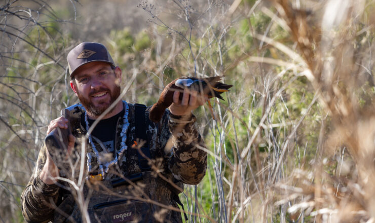 Eric Strand, a hunter with Born and Raised Outdoors, shows off a duck he shot during a waterfowl hunt at Stuart Mesa pond on Marine Corps Base Camp Pendleton, California, Jan. 16, 2021. Pendleton Marines teamed up with Born and Raised Outdoors to enjoy the sport of hunting and help bring awareness to to the installation's wildlife conservation efforts. Pendleton’s game wardens allow hunting on base to aid in managing wildlife population levels. (U.S. Marine Corps photo by Lance Cpl. Andrew Cortez)