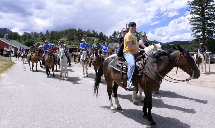 Air Force Wounded Warriors prepare for a trail ride at the U.S. Air Force Academy Equestrian Center in Colorado Springs, Colo., July 22, 2015. The Air Force Wounded Warriors Program led an outdoor sports experience across the Front Range at the Air Force Academy to build support and trust for dozens of service members July 20-July 24, 2015. The Air Force Wounded Warriors spent time riding horses on Academy trails and tackling the Academy's ropes course in the cadet area. (Air Force photo/Mike Kaplan)